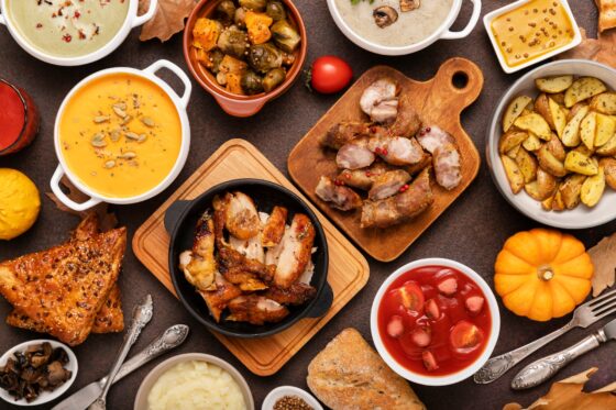 Detalle de una mesa repleta de platos y tapas, ambiente de comida para compartir